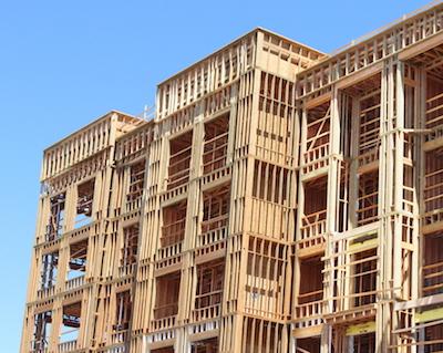 Unfinished wood-frame multi-family/mixed use building exterior